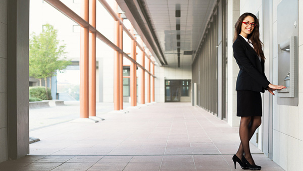 Professional woman using the ATM