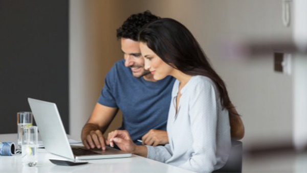 A man teaching a woman to use laptop A man teaching a woman to use laptop