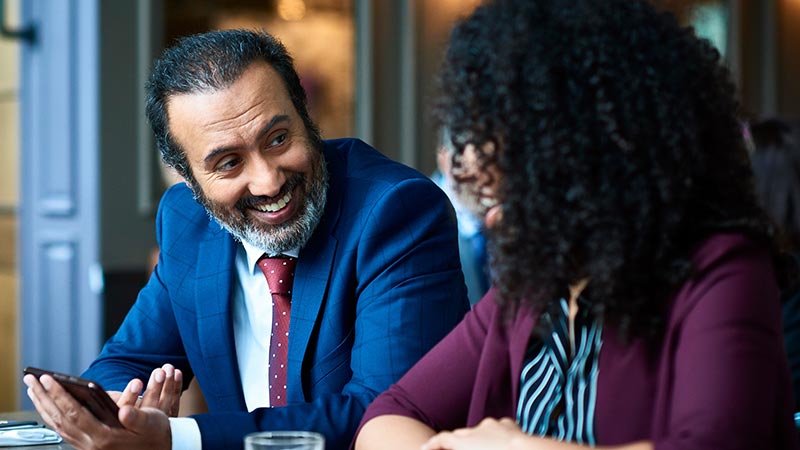 Two professionals casually conversing Two professionals casually conversing