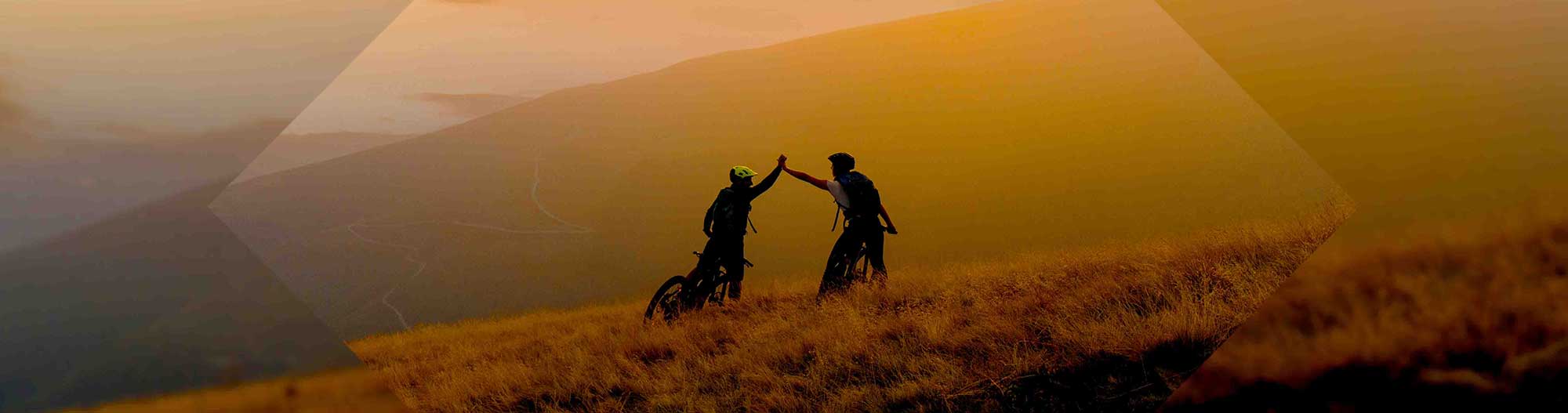 Mountain cyclists giving high five Mountain cyclists giving high five